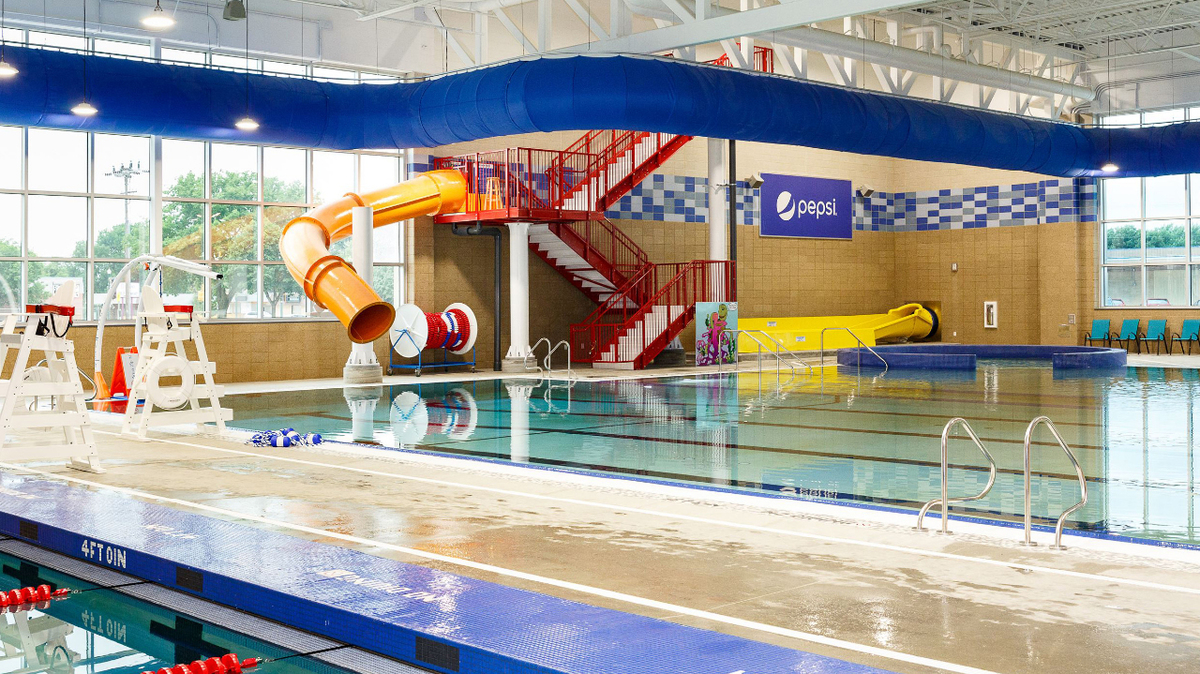 Indoor leisure pool and water slide plunge zone at Mitchell Aquatic Center